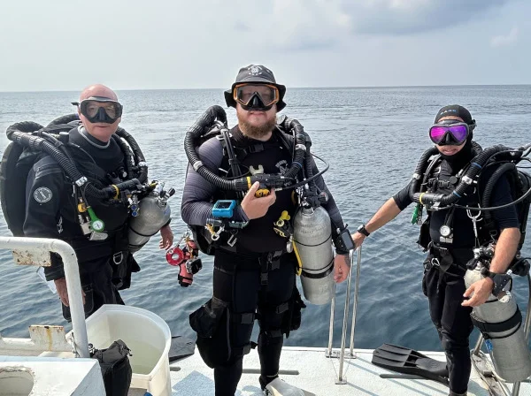 three AP Inspiration divers on the boat getting ready to do their 40m rebreather course